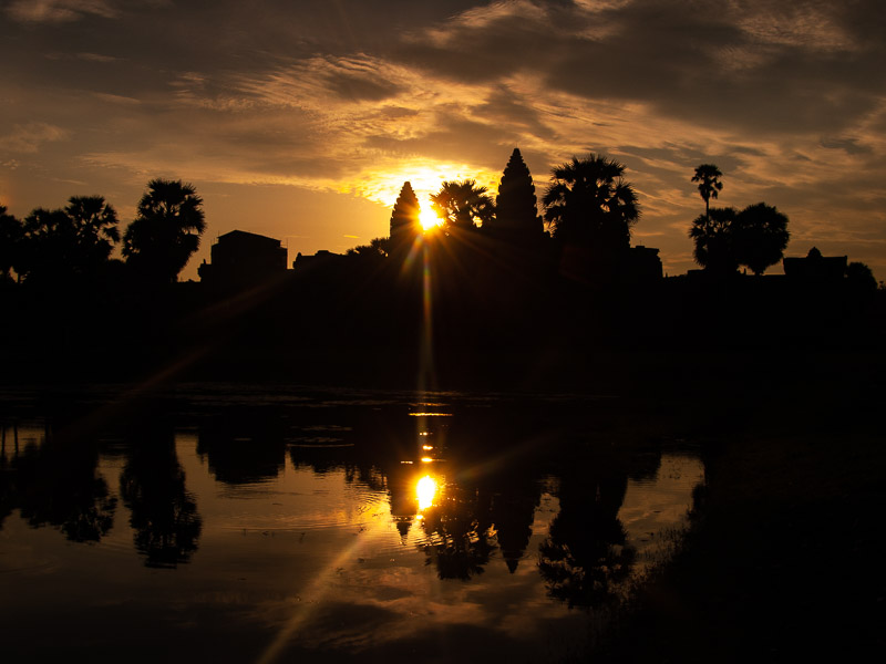 Silhouette and reflection of Angkor Wat in the pond