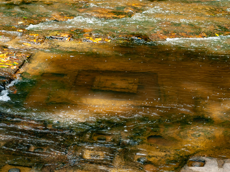 Tiles carved into the stream's bedrock