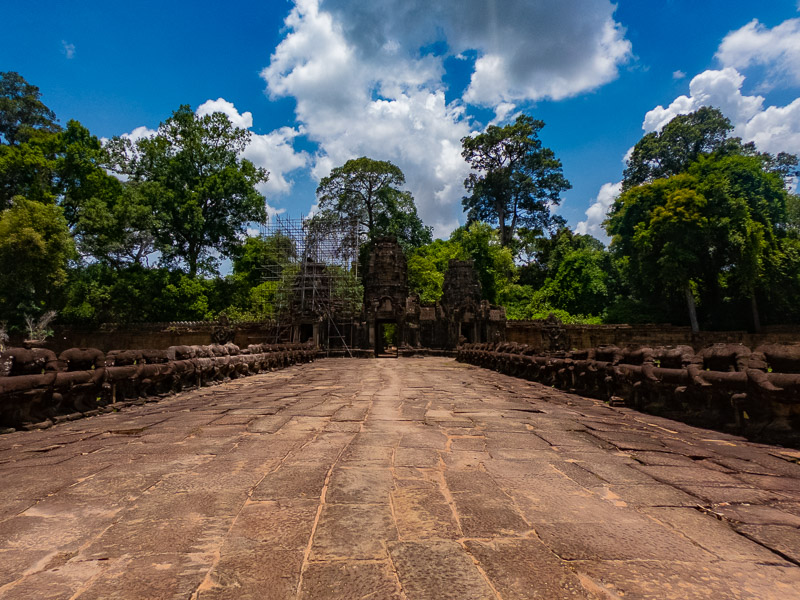 Bridge with headless statues leading to the temple