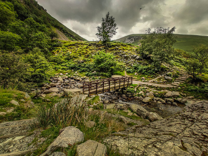 Wooden bridge to cross the small river