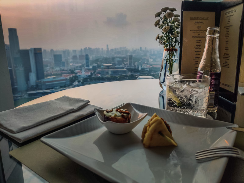 Canpés and drinks at Club55 with a city view