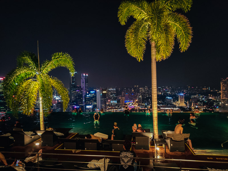 The infinity pool with the city in skyline in the background