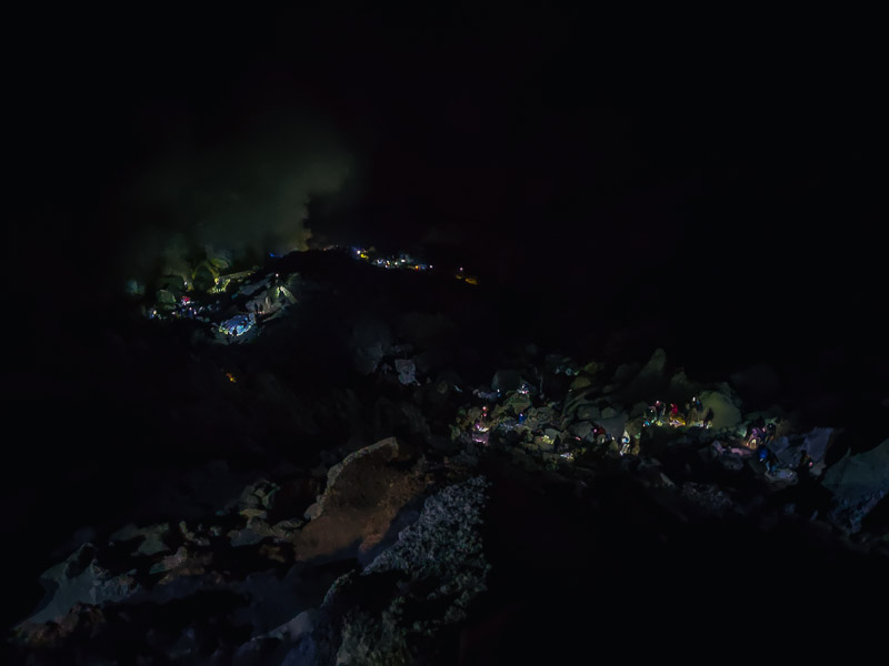 Flashlights on the trail down the crater