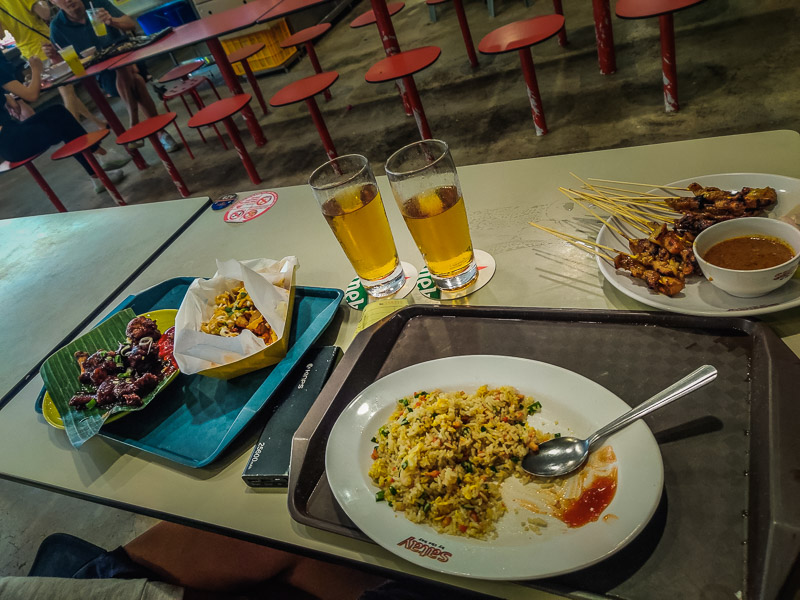 Lollipop chicken, cheese wedges, fried rice, and an arrangement of satay skewers