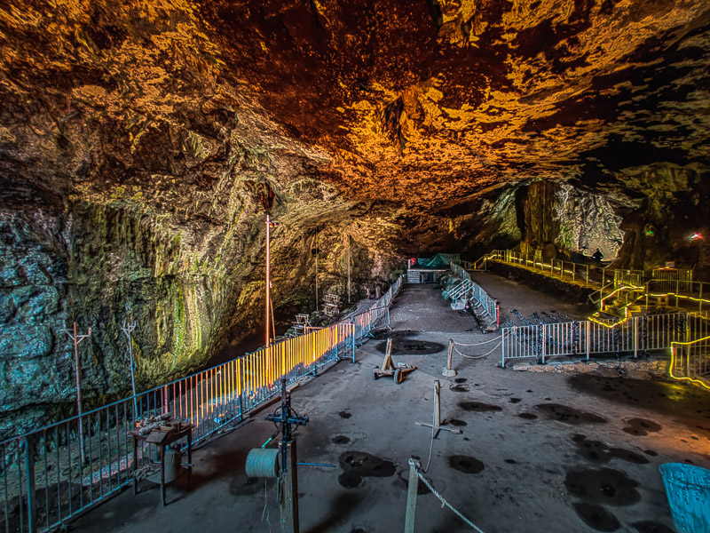 Cave entrance with rope making equipment on display