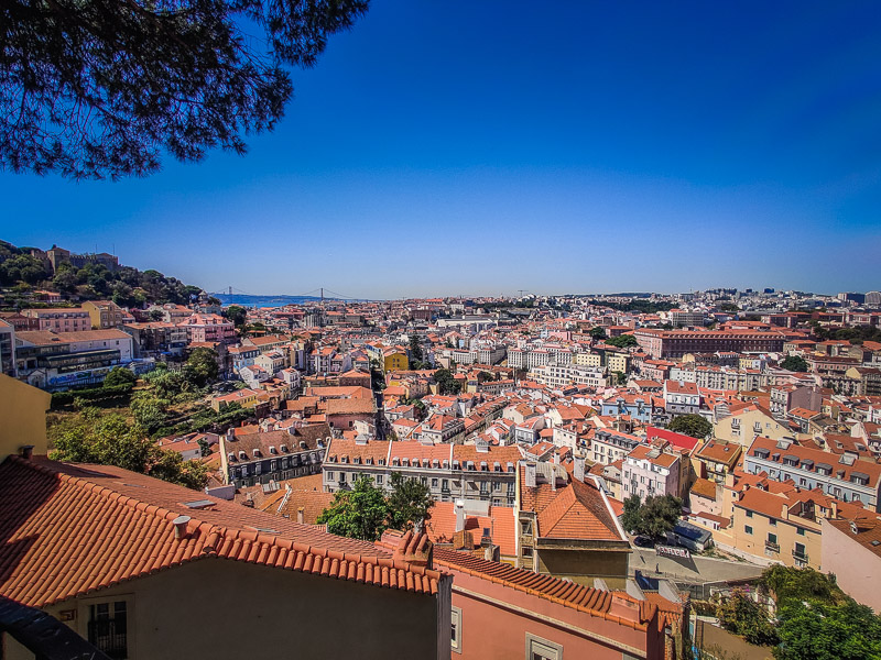 View of the red-roofed city and the suspension bridge