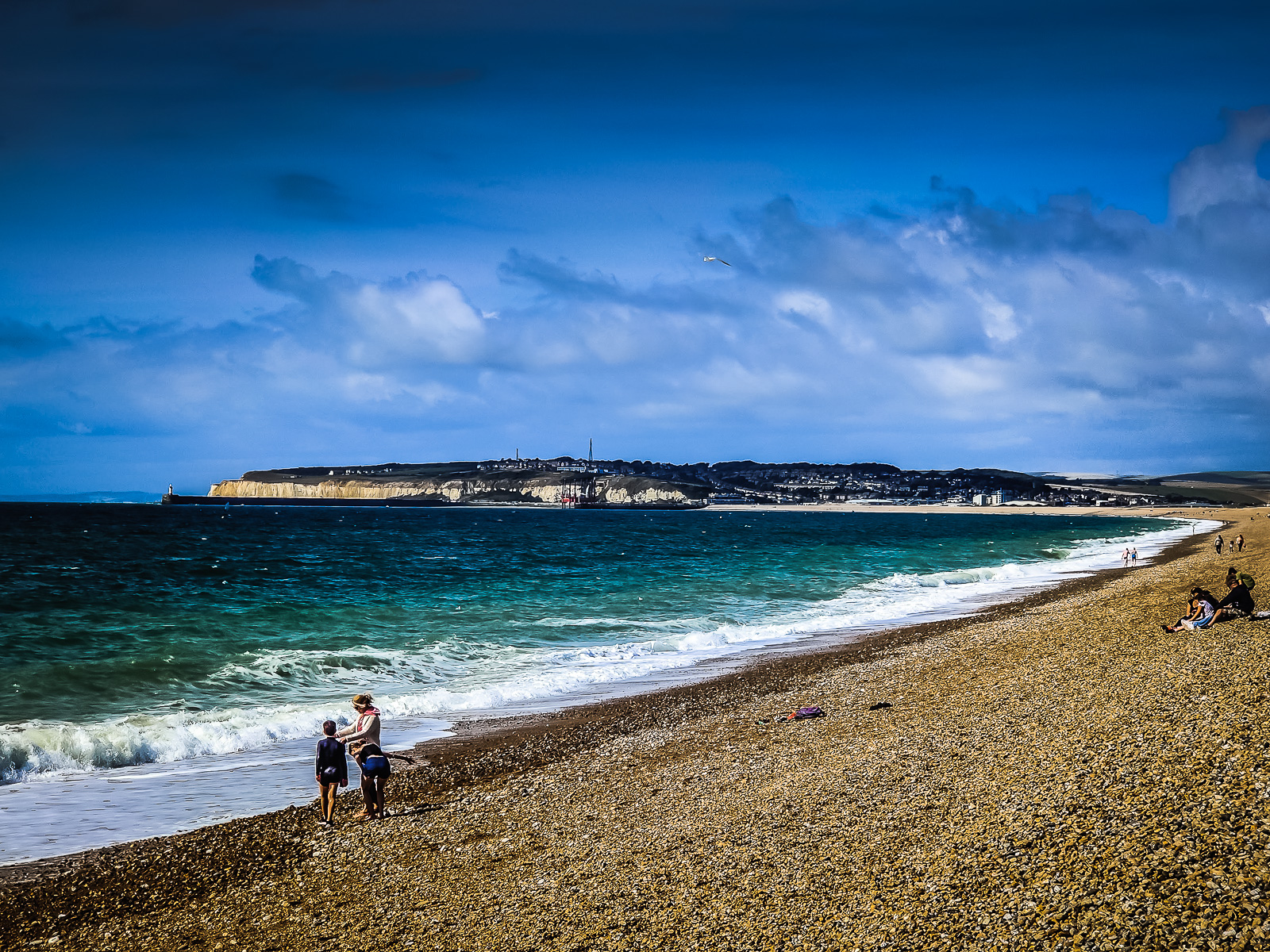 The stone beach with white cliffs in the distance